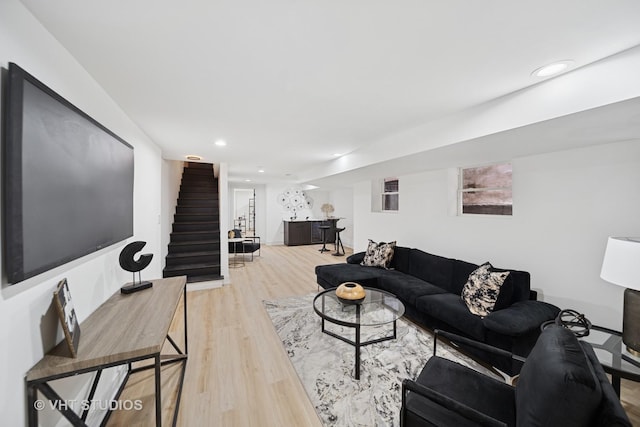 living area featuring light wood-style floors, stairway, and recessed lighting