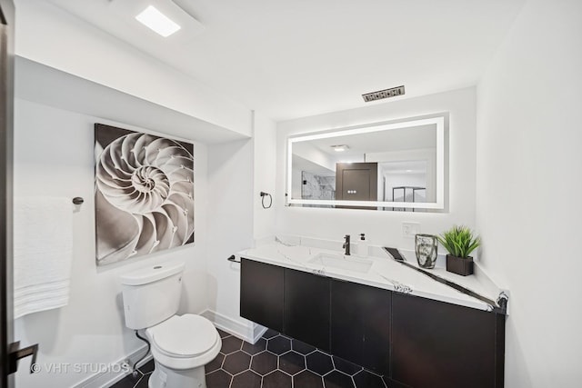 bathroom with toilet, baseboards, visible vents, tile patterned flooring, and vanity