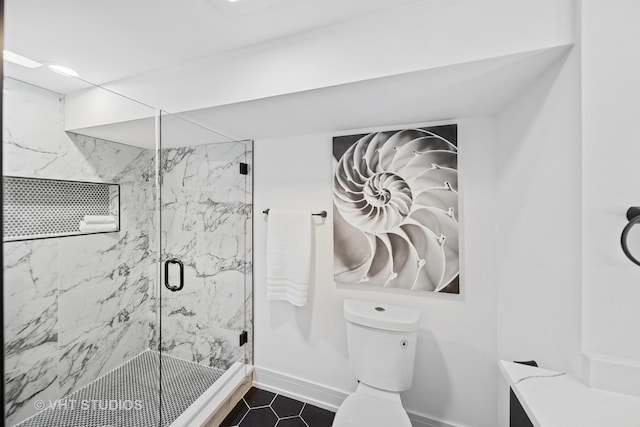 full bath with tile patterned floors, toilet, a marble finish shower, and baseboards