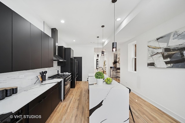 kitchen with dark cabinets, pendant lighting, a kitchen island with sink, high end stainless steel range oven, and modern cabinets