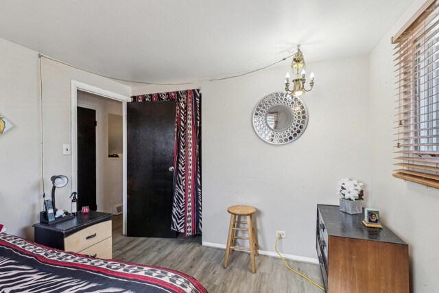 16641 Honore Ave, Markham, IL 60428 - bedroom featuring wood finished floors, an inviting chandelier, and baseboards