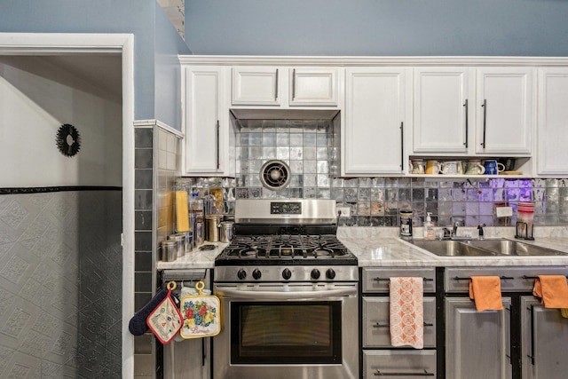 16641 Honore Ave, Markham, IL 60428 - kitchen with stainless steel range with gas stovetop, white cabinetry, visible vents, a sink, and light countertops