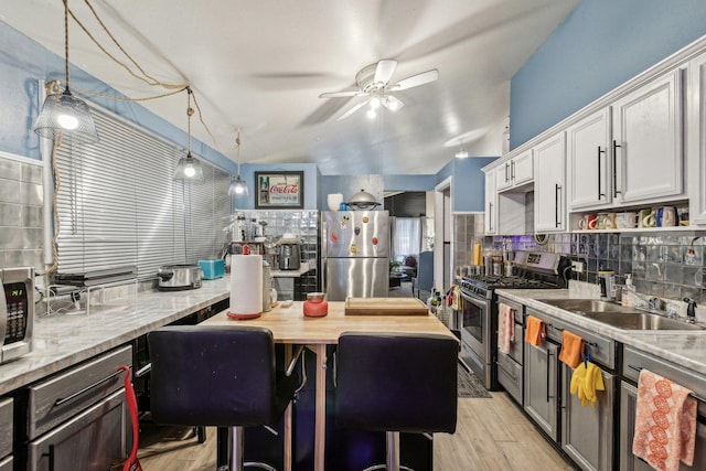 16641 Honore Ave, Markham, IL 60428 - kitchen featuring a sink, decorative backsplash, ceiling fan, and stainless steel appliances
