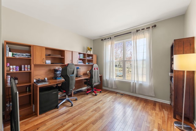 home office with baseboards, visible vents, and light wood-style floors