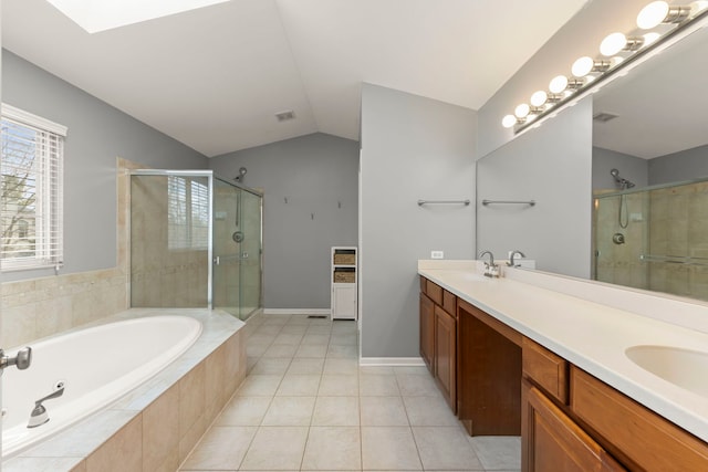 bathroom with a sink, a stall shower, lofted ceiling, and a garden tub
