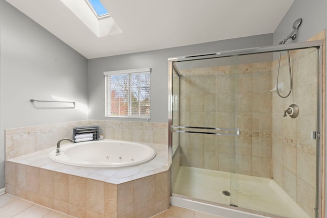 full bathroom with a shower stall, a whirlpool tub, lofted ceiling with skylight, and tile patterned floors