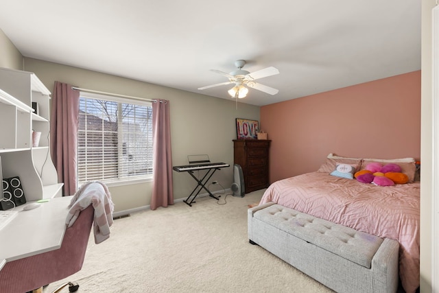 carpeted bedroom featuring baseboards and a ceiling fan