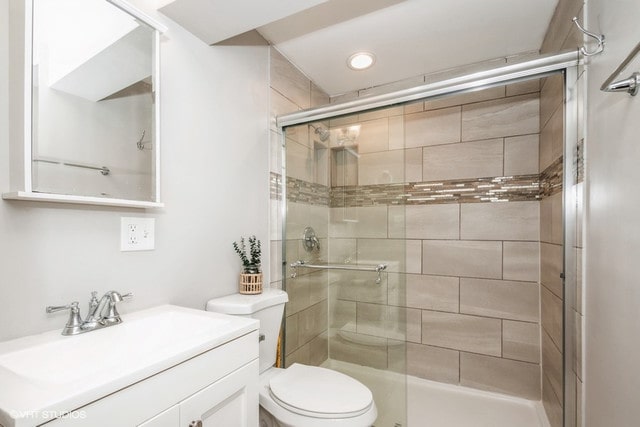 318 N Oaklawn Ave, Elmhurst, IL 60126 - bathroom featuring a stall shower, toilet, vanity, and recessed lighting