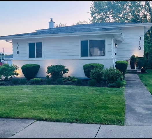 318 N Oaklawn Ave, Elmhurst, IL 60126 - view of front of house with a chimney, a lawn, and brick siding