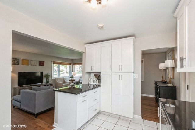 318 N Oaklawn Ave, Elmhurst, IL 60126 - kitchen with a peninsula, open floor plan, white cabinetry, baseboards, and light tile patterned floors