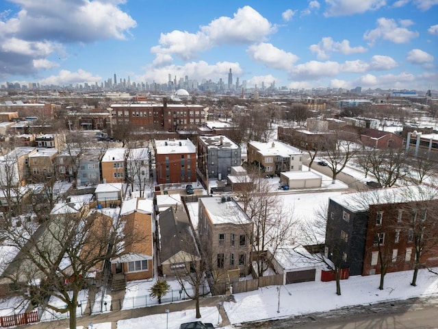 snowy aerial view featuring a city view