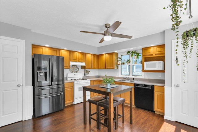 2203 E Pennsylvania Ave, Urbana, IL 61802 - kitchen featuring black appliances, a sink, under cabinet range hood, ceiling fan, and dark wood finished floors