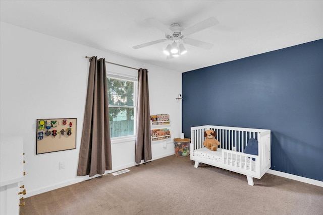 2203 E Pennsylvania Ave, Urbana, IL 61802 - carpeted bedroom featuring a nursery area, ceiling fan, and baseboards