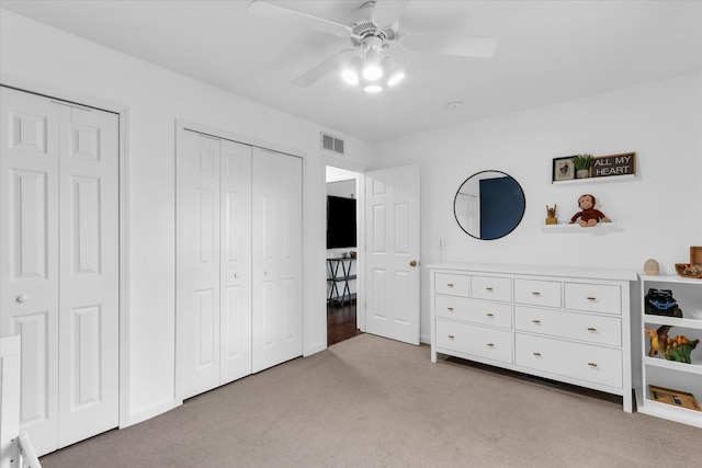 2203 E Pennsylvania Ave, Urbana, IL 61802 - bedroom featuring light colored carpet, two closets, and ceiling fan