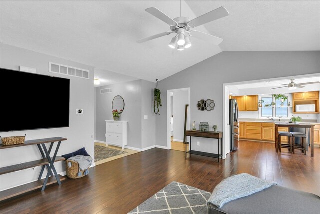 2203 E Pennsylvania Ave, Urbana, IL 61802 - living room featuring a ceiling fan, vaulted ceiling, dark wood-style flooring, and baseboards