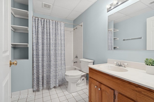 bathroom featuring visible vents, vanity, tile patterned floors, toilet, and a drop ceiling