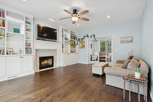 living room with visible vents, ceiling fan, recessed lighting, a tile fireplace, and dark wood finished floors