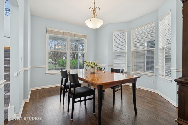 dining room with baseboards, stairs, and dark wood-type flooring