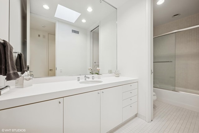 full bathroom featuring visible vents, toilet, a skylight, vanity, and tile patterned floors