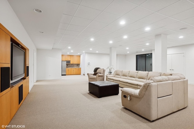 living room with light colored carpet, baseboards, and recessed lighting