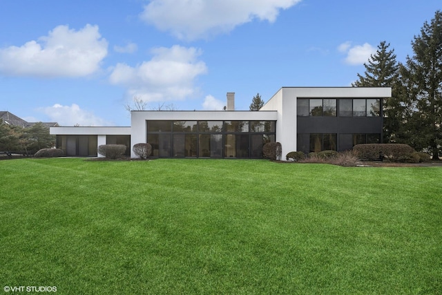 exterior space with an attached garage, a yard, and stucco siding