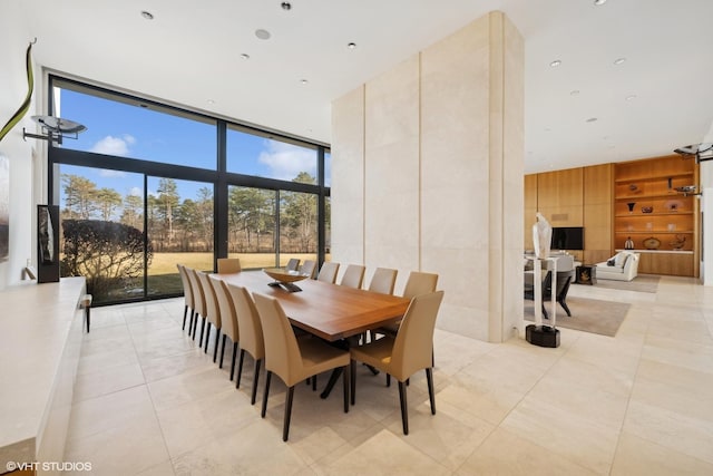 dining room with expansive windows, light tile patterned floors, and built in shelves