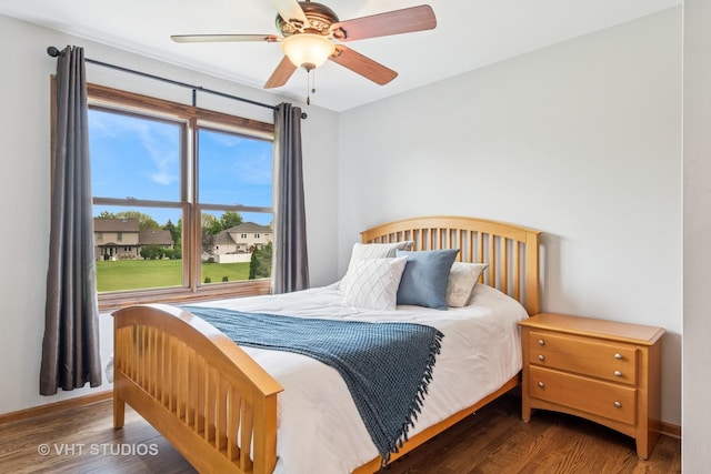 bedroom with wood finished floors, a ceiling fan, and baseboards