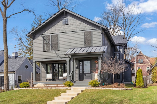 410 S River Ln, Geneva, IL 60134 - view of front facade with fence, a standing seam roof, a porch, a front yard, and metal roof