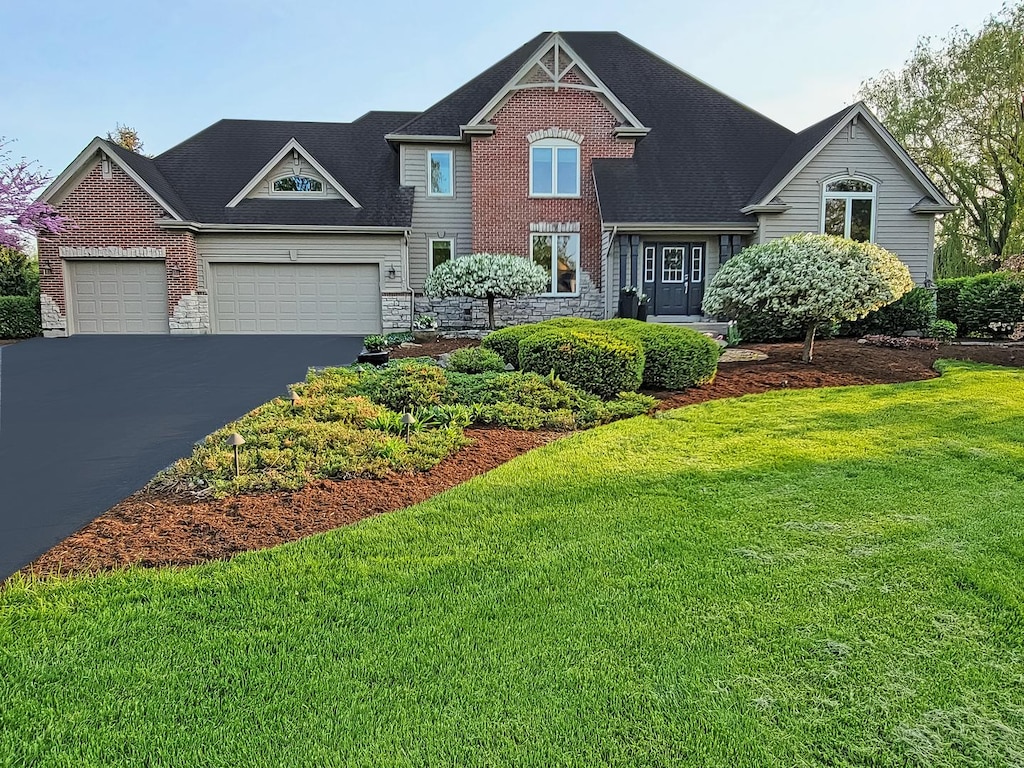 39W267 Meadowview Ct, Saint Charles, IL 60175 - view of front facade with stone siding, a garage, driveway, and a front yard