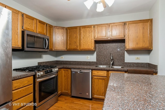 25W704 Jewell Rd, Wheaton, IL 60187 - kitchen featuring appliances with stainless steel finishes, light wood-style floors, a ceiling fan, brown cabinets, and decorative backsplash