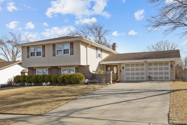 1165 Mayfield Ln, Hoffman Estates, IL 60169 - tri-level home featuring brick siding, concrete driveway, a front yard, a chimney, and an attached garage