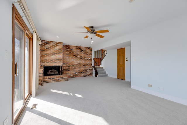 1165 Mayfield Ln, Hoffman Estates, IL 60169 - unfurnished living room featuring a wealth of natural light, a brick fireplace, stairs, and ceiling fan
