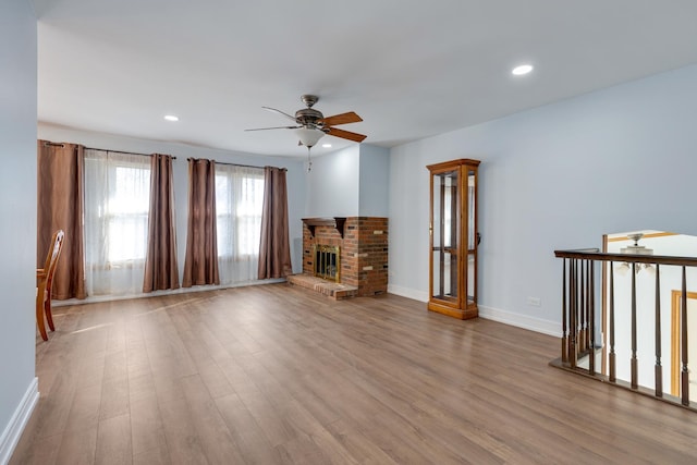 1165 Mayfield Ln, Hoffman Estates, IL 60169 - unfurnished living room with recessed lighting, a brick fireplace, wood finished floors, and a ceiling fan
