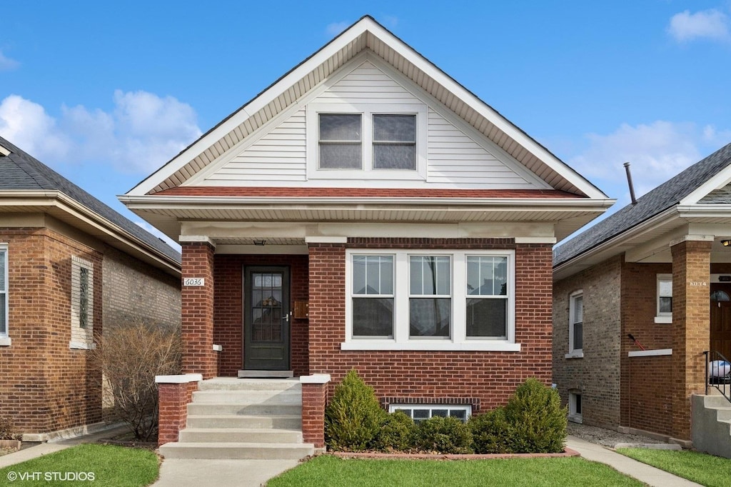 bungalow-style house featuring brick siding