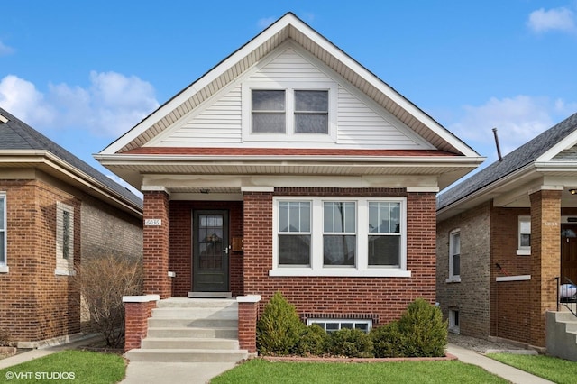 bungalow-style house featuring brick siding