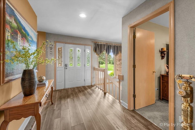 foyer with baseboards, recessed lighting, and wood finished floors