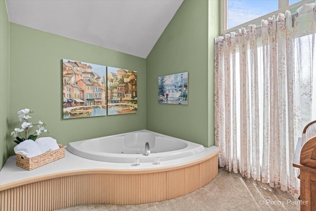 bathroom with a whirlpool tub and vaulted ceiling