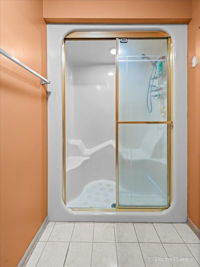 bathroom featuring tile patterned floors and a stall shower