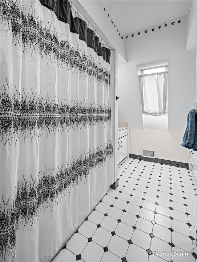 bathroom featuring visible vents, tile patterned floors, and vanity