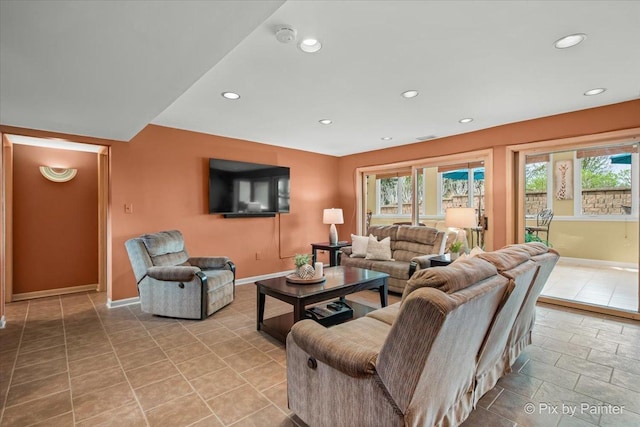 living room with recessed lighting and baseboards