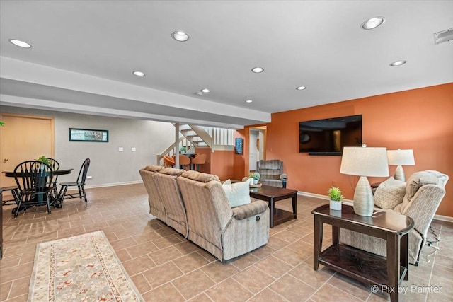 living room featuring recessed lighting, baseboards, and stairway