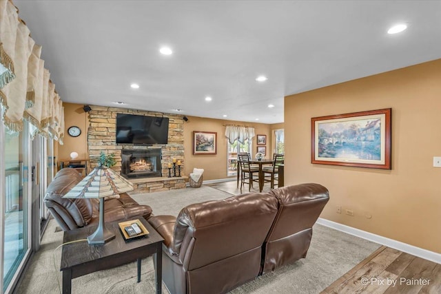 living room with recessed lighting, baseboards, wood finished floors, and a fireplace