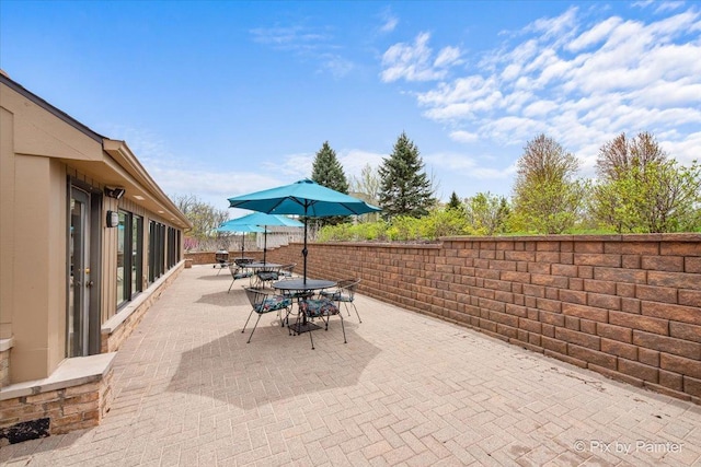 view of patio with fence and outdoor dining space