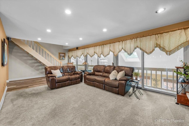 carpeted living room with stairs, recessed lighting, baseboards, and a healthy amount of sunlight