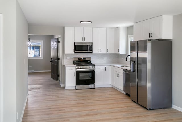 15439 Cherry St, South Holland, IL 60473 - kitchen featuring appliances with stainless steel finishes, tasteful backsplash, baseboards, light countertops, and white cabinets