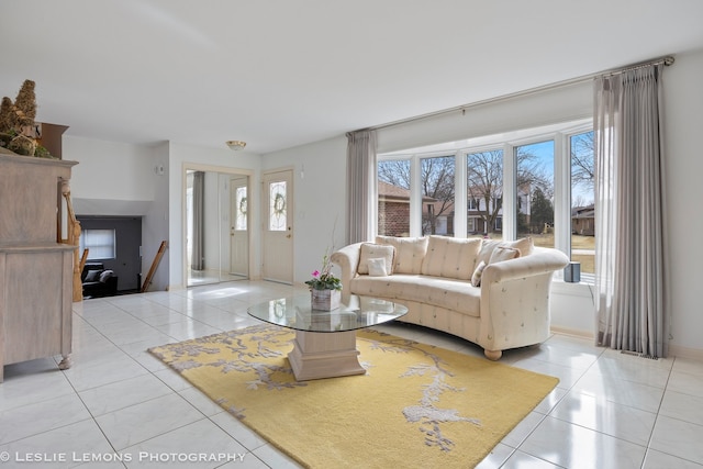 living room with light tile patterned floors and baseboards