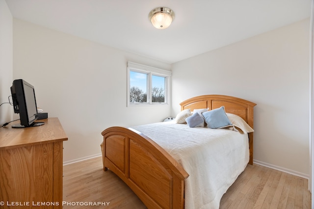 bedroom featuring baseboards and light wood-type flooring