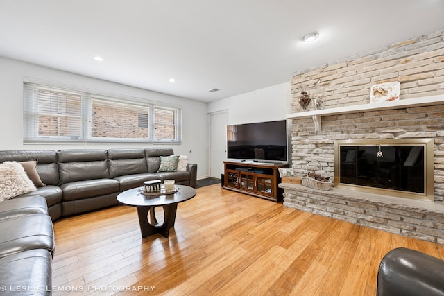 living room featuring recessed lighting, visible vents, and wood finished floors