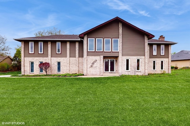 17N560 Hidden Hills Trl, Dundee, IL 60118 - rear view of property featuring a chimney and a lawn