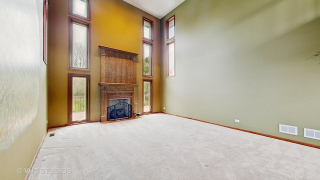 17N560 Hidden Hills Trl, Dundee, IL 60118 - unfurnished living room with a towering ceiling, a wealth of natural light, and carpet flooring